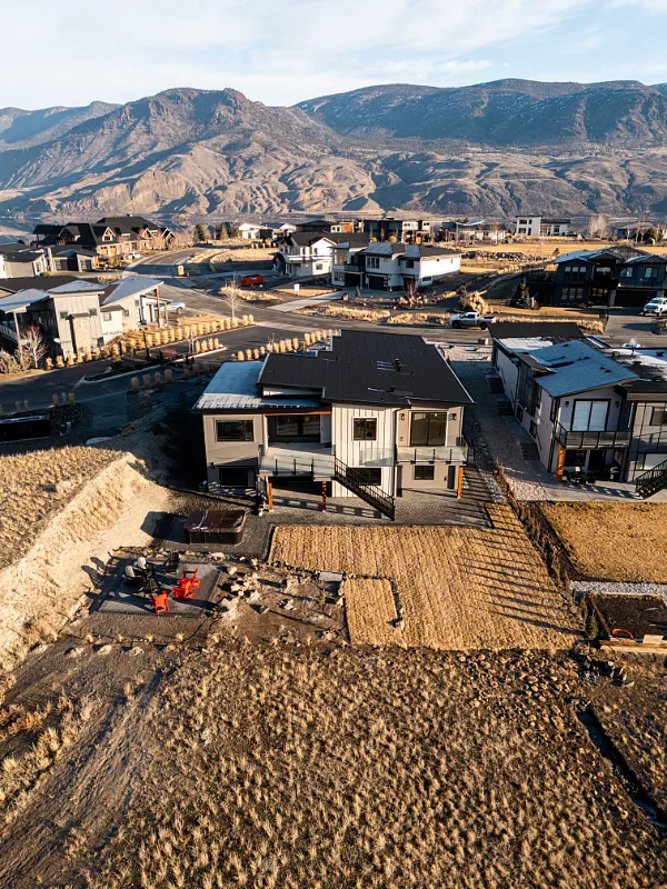 Aerial view of a custom new home build in Tobiano, BC by Double G Construction